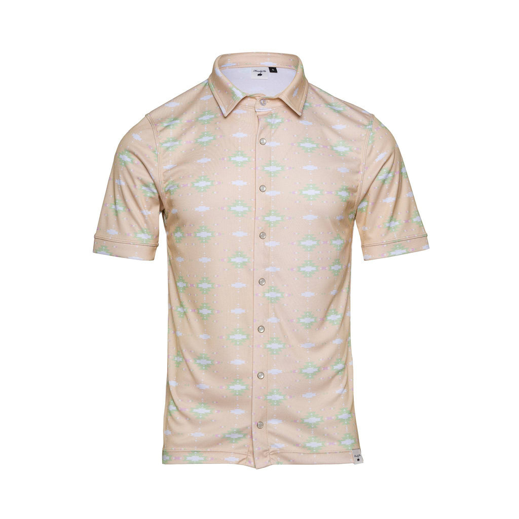 The Sunrise Serenity shirt displayed against a white background, showcasing a tan color with a soft pattern of green and white floral motifs. The shirt features a classic collar, short sleeves, and a row of neat, visible button closures, giving it a crisp, summer-ready look.